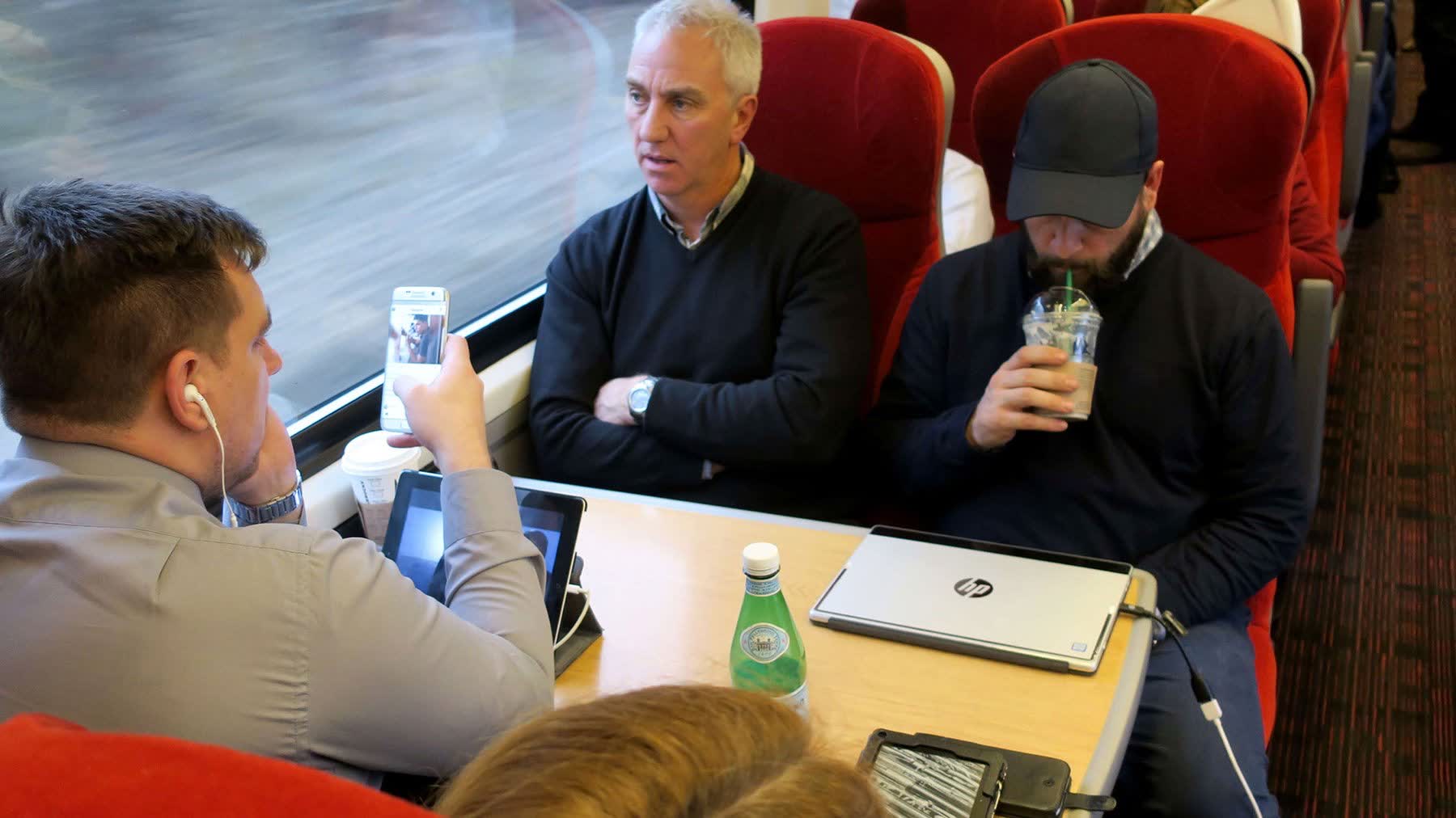 Researcher conducting intercept interview on train