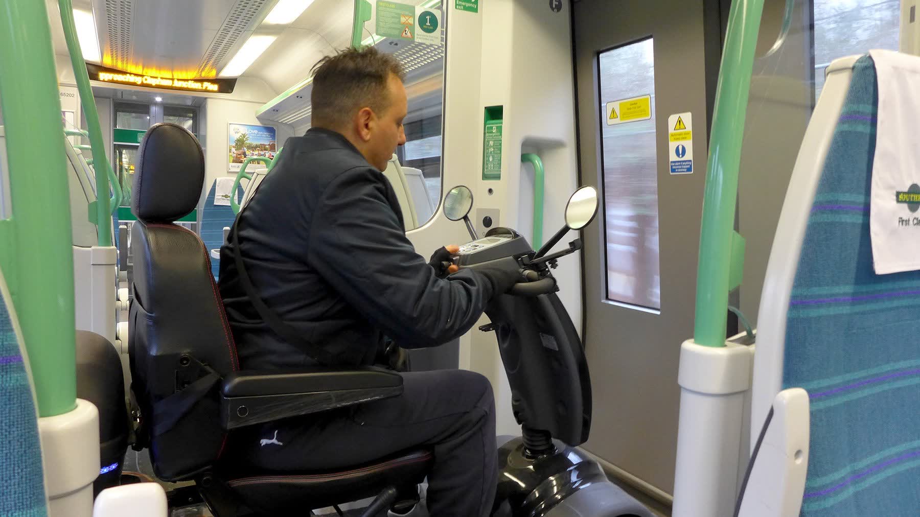 Mobility scooter user navigating train carriage